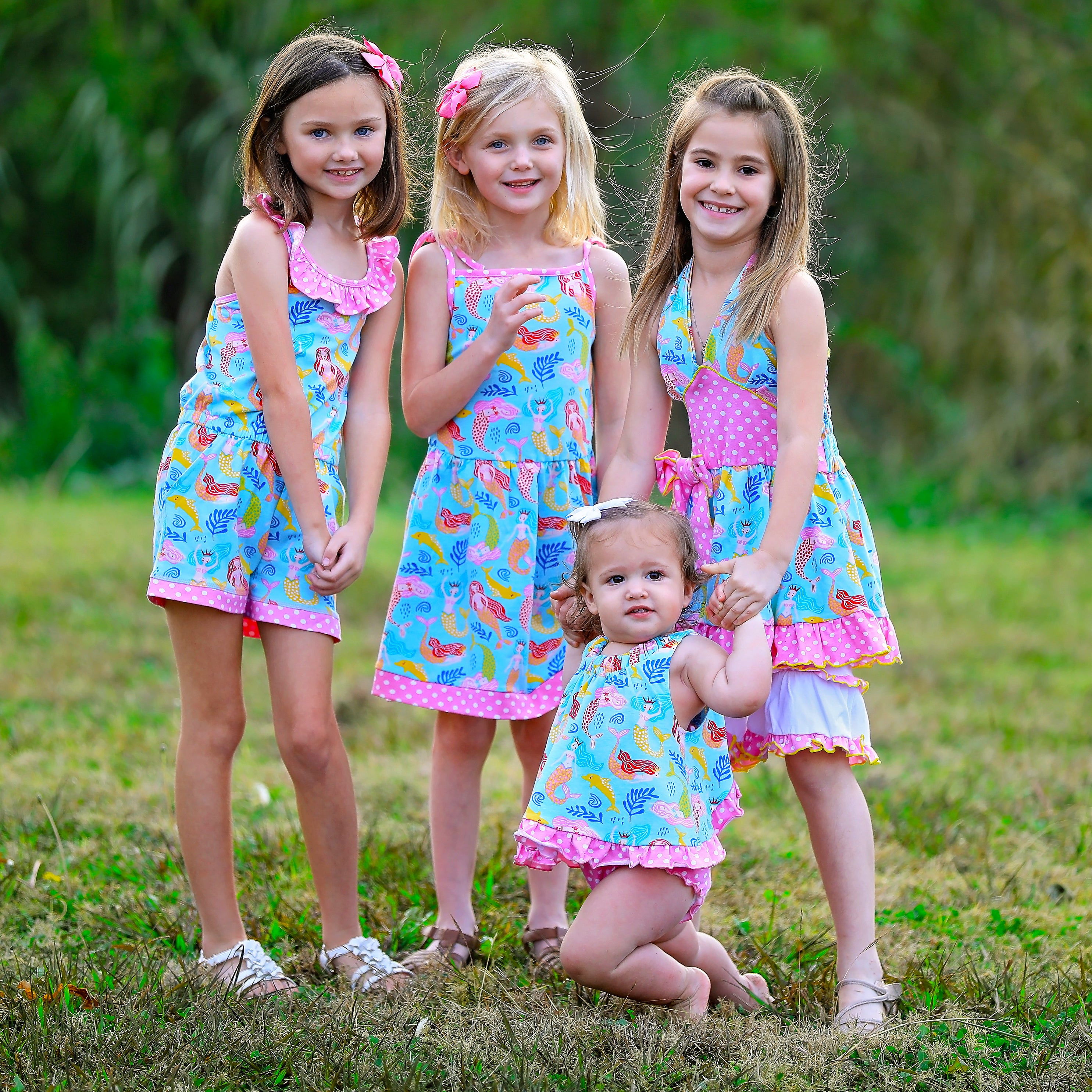 AnnLoren Girls Mermaid Halter Dress featuring a pink polka dot waistband and big bow, paired with white ruffle shorts, perfect for summer wear.